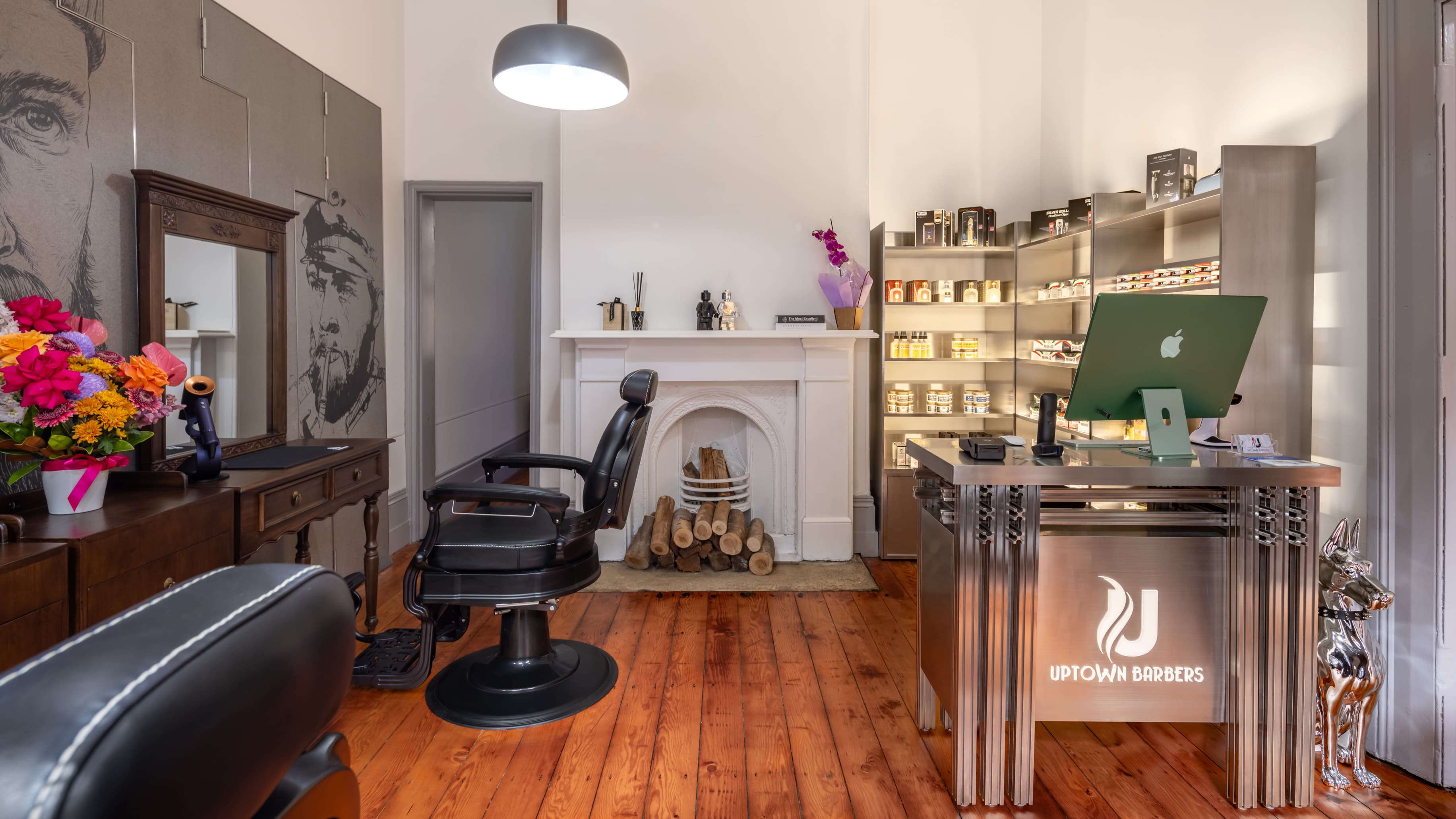 Inside UPTOWN Barbers at The Rocks, with grooming products displayed on the shop shelves